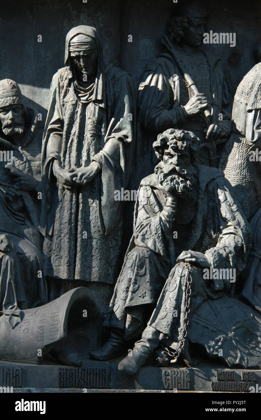 Marfa Boretskaya (L) who led the struggle of the Novgorod Republic against Muscovy and Cossack leader Yermak Timofeyevich (R) who started the Russian conquest of Siberia depicted in the bas relief dedicated to Russian military leaders and heroes by Russian sculptors Matvey Chizhov and Alexander Lubimov. Detail of the Monument to the Millennium of Russia (1862) designed by Mikhail Mikeshin in Veliky Novgorod, Russia. Prince Mikhail Skopin-Shuisky who was the military leader during the Time of Troubles is depictedin the background in the right. The broken Novgorod veche bell is depicted in front Stock Photo