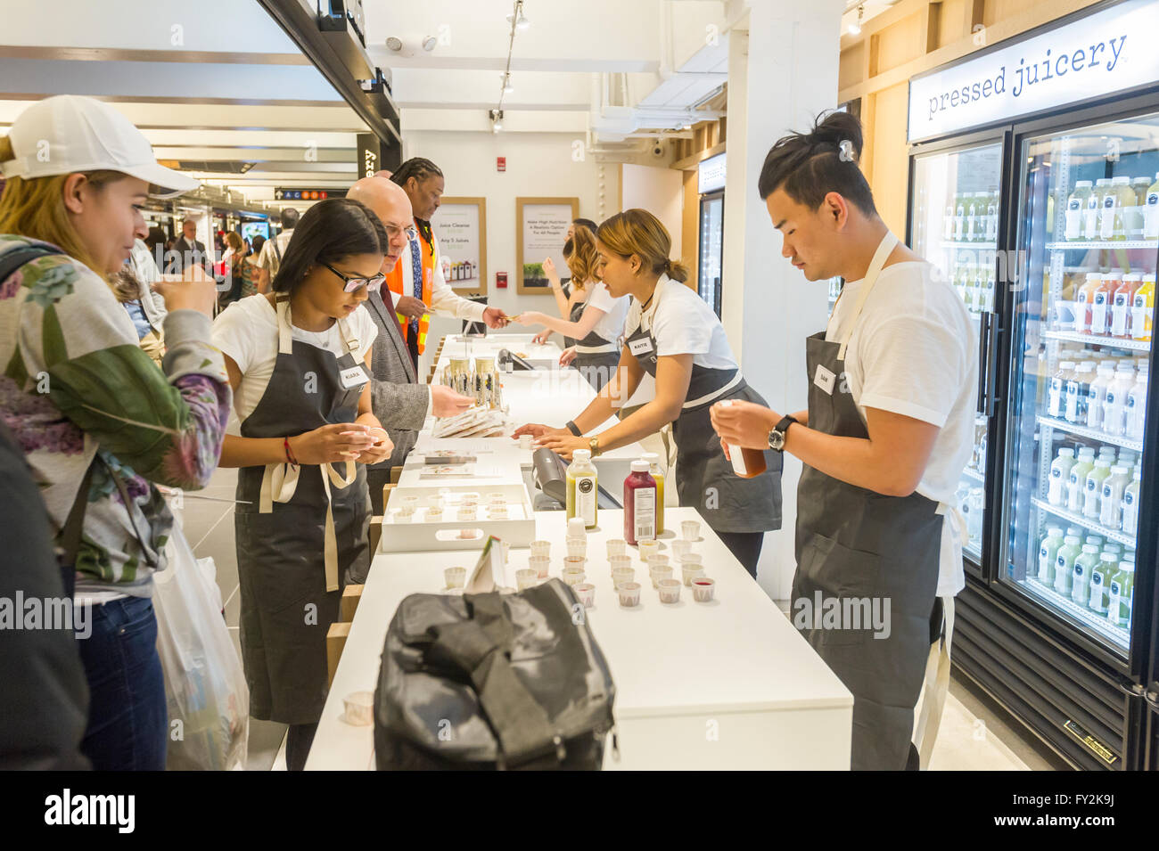 Workers in Pressed Juice give out samples in the Columbus Circle