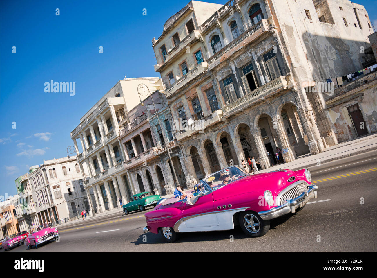 Horizontal view of classic American cars driving down the Malecon in Havana, Cuba. Stock Photo