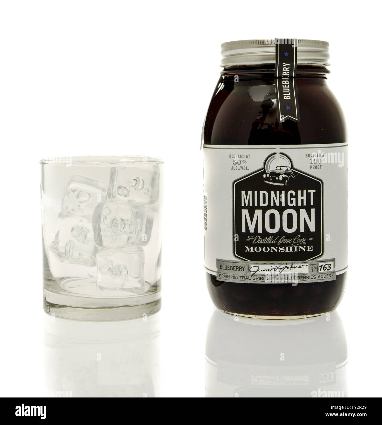 Winneconne, WI - 15 March 2016:  A bottle of Midnight Moon moonshine with a glass of ice Stock Photo
