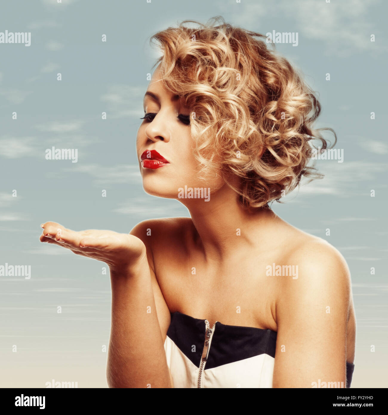 young beautiful blond Female blowing kissed to her valentine Stock Photo