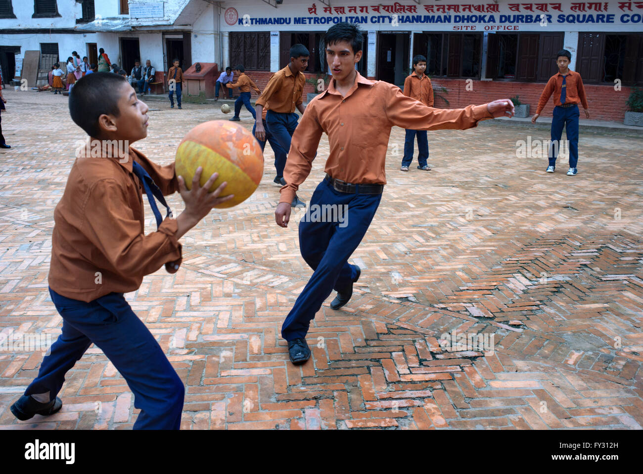 Local students play with a ball in Kathmandu Metropolitan City Hanuman Dhoka Durbar Square, Kathmandu, Nepal. Stock Photo