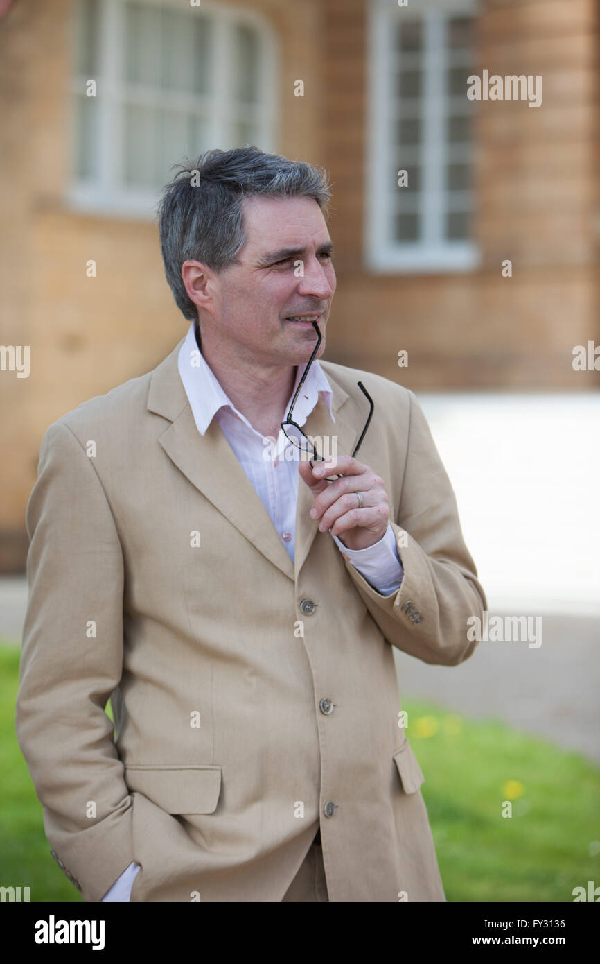 Man in tan suit leaning hi-res stock photography and images - Alamy