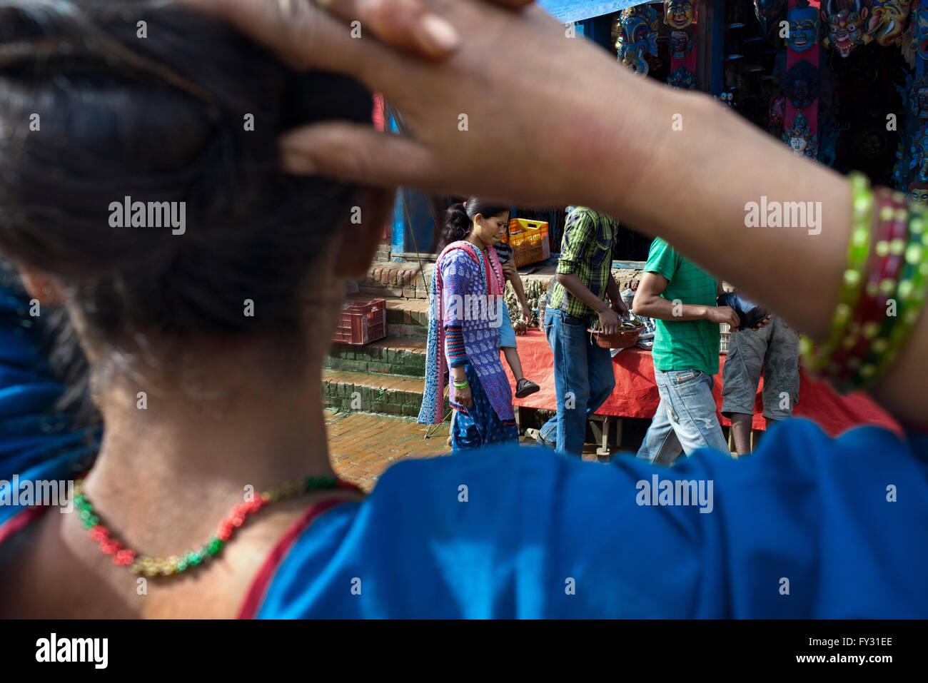 Woman back. Morning market at Bhaktapur's Durbar Square, Kathmandu, Nepal. Stock Photo