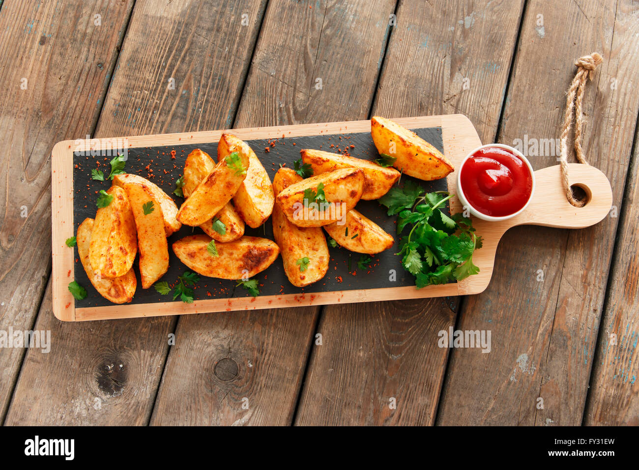 baked roasted potato wedges with herbs Stock Photo