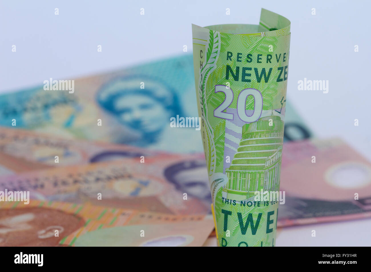nz-dollars-rolled-with-a-background-of-notes-stock-photo-alamy