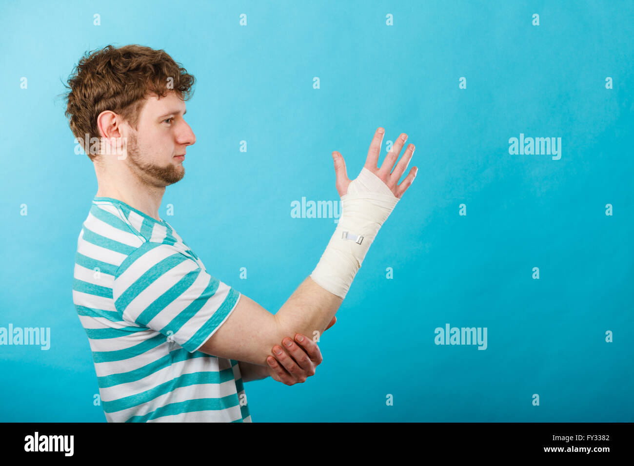 Fractures and dislocations concept. Man with hand in bandage. Helpful