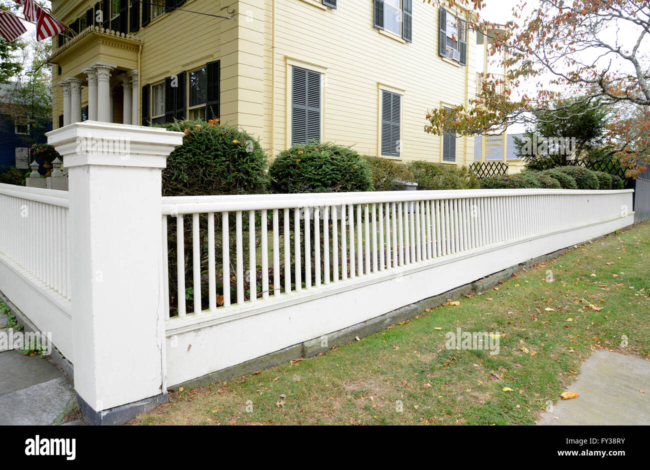white picket fence by a typical federal style house in Stonington Connecticut Stock Photo