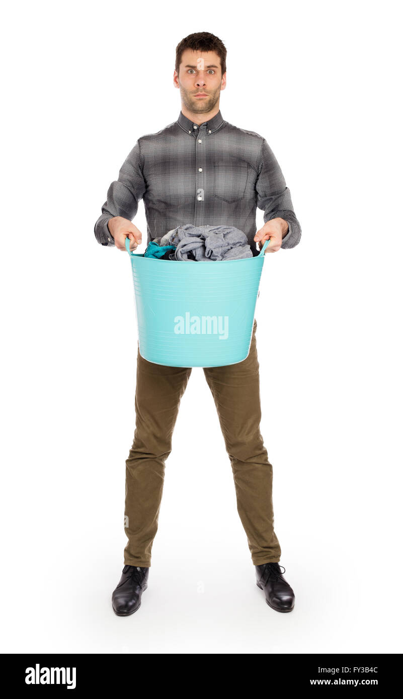 Full length portrait of a young man holding a laundry basket isolated on white background Stock Photo