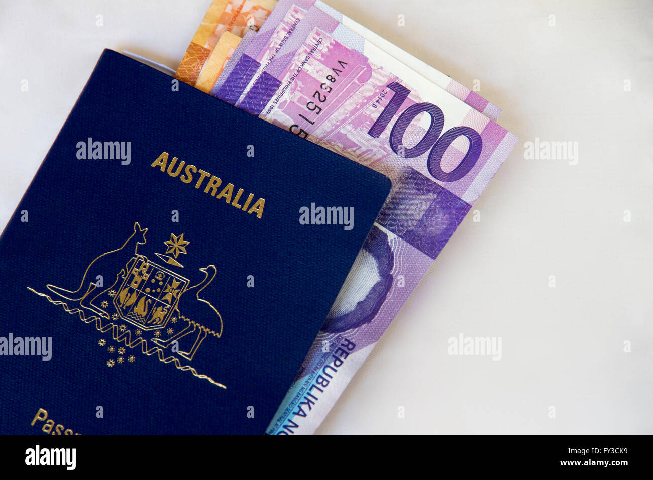 Australian passport and Phillipino cash to travel Stock Photo -