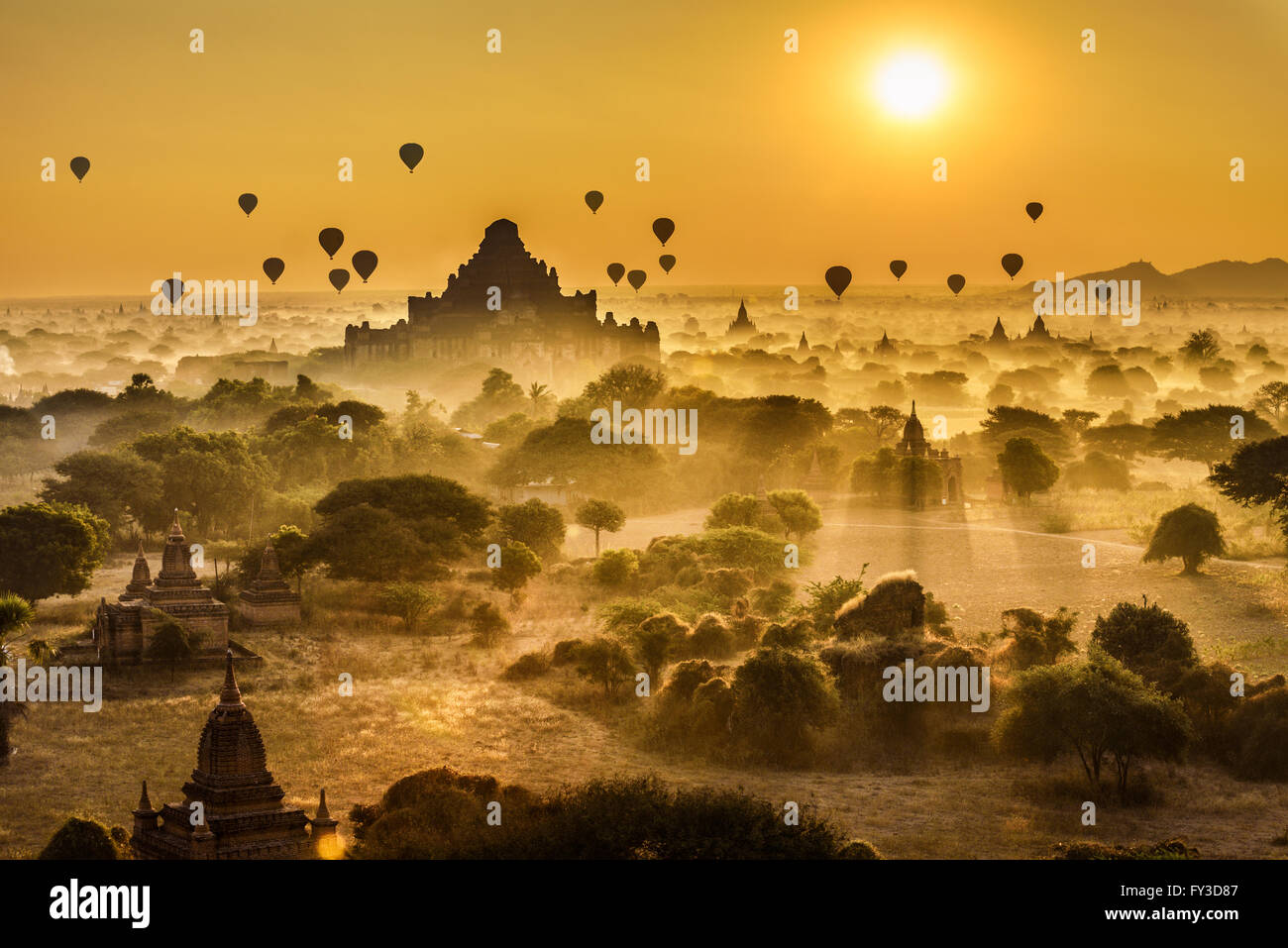 Scenic sunrise with many hot air balloons above Bagan in Myanmar. Bagan is an ancient city with thousands of historic buddhist t Stock Photo