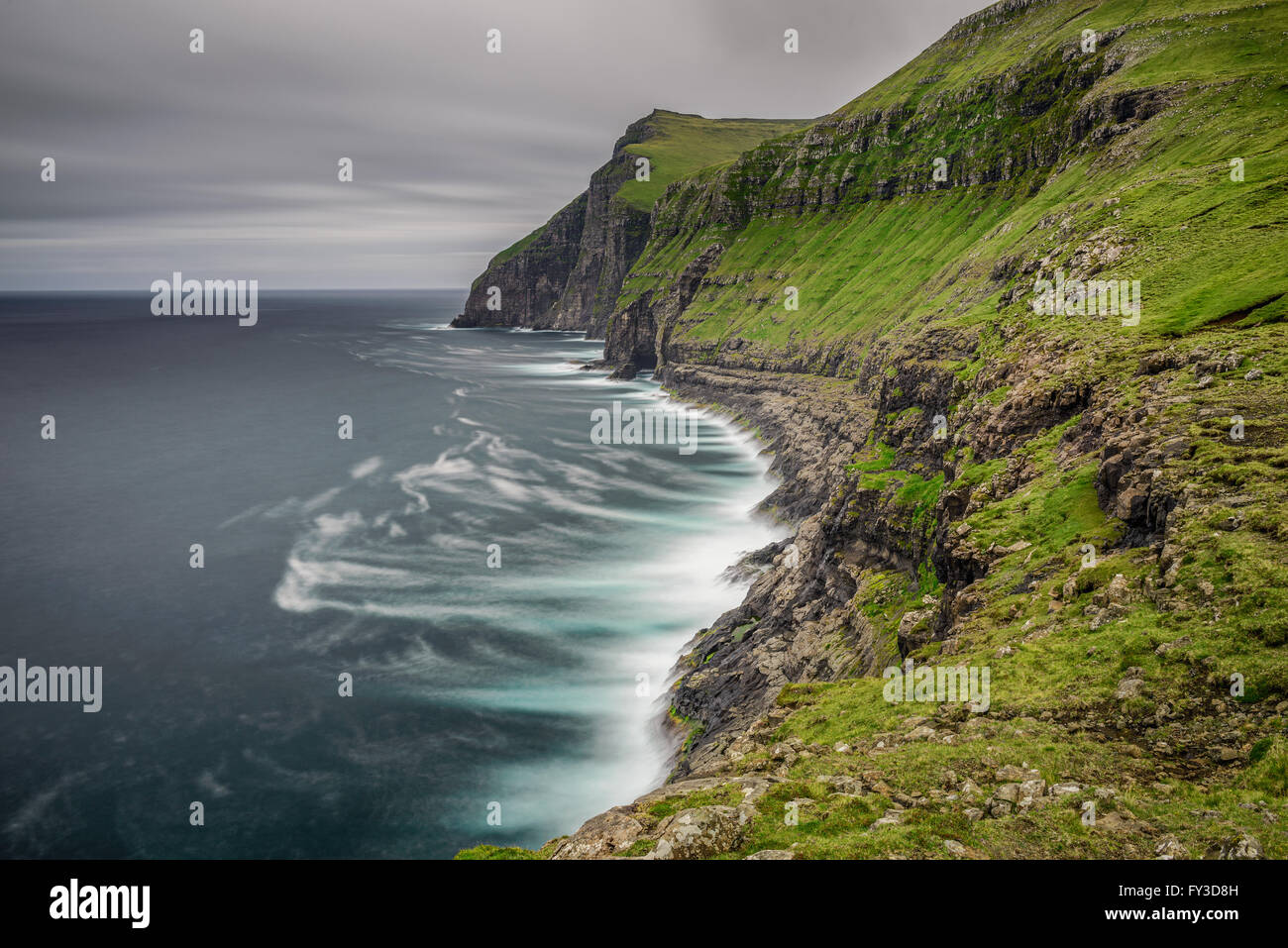 Giant sea cliffs shortly after storm on Faroe Islands. Long exposure. Stock Photo
