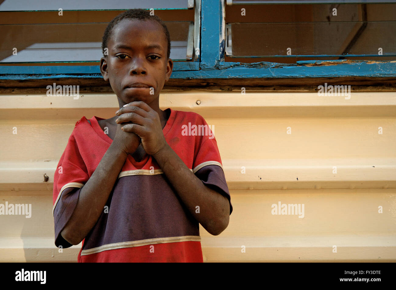 African boy in front of a building in a street of Lilongwe, Central Region, capital city of Malawi Stock Photo