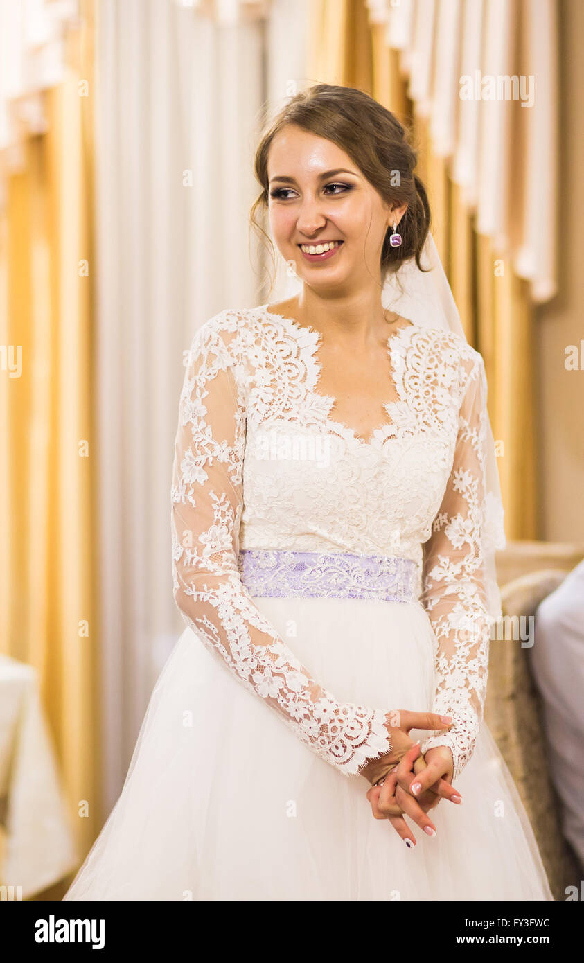 Portrait of beautiful young bride in elegant white dress indoors Stock ...
