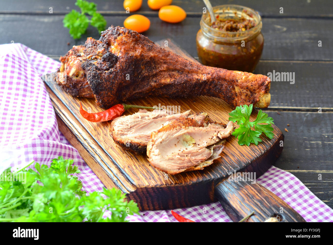 Roast turkey drumstick on a dark wooden table Stock Photo