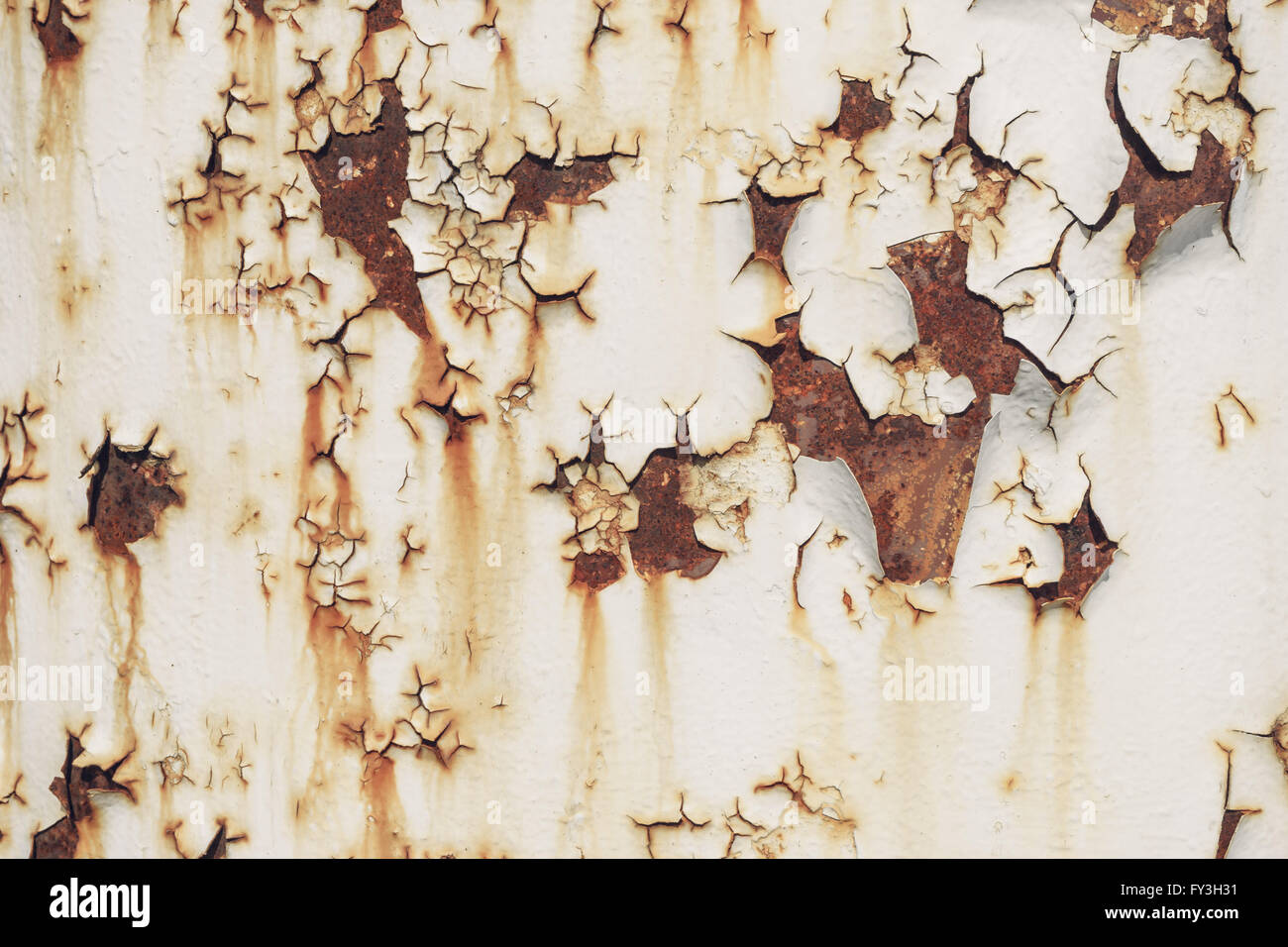 Weathered and worn crusted paint on metal wall background Stock Photo