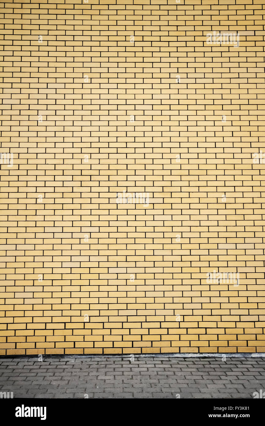 Modern vibrant yellow brick wall as a background Stock Photo