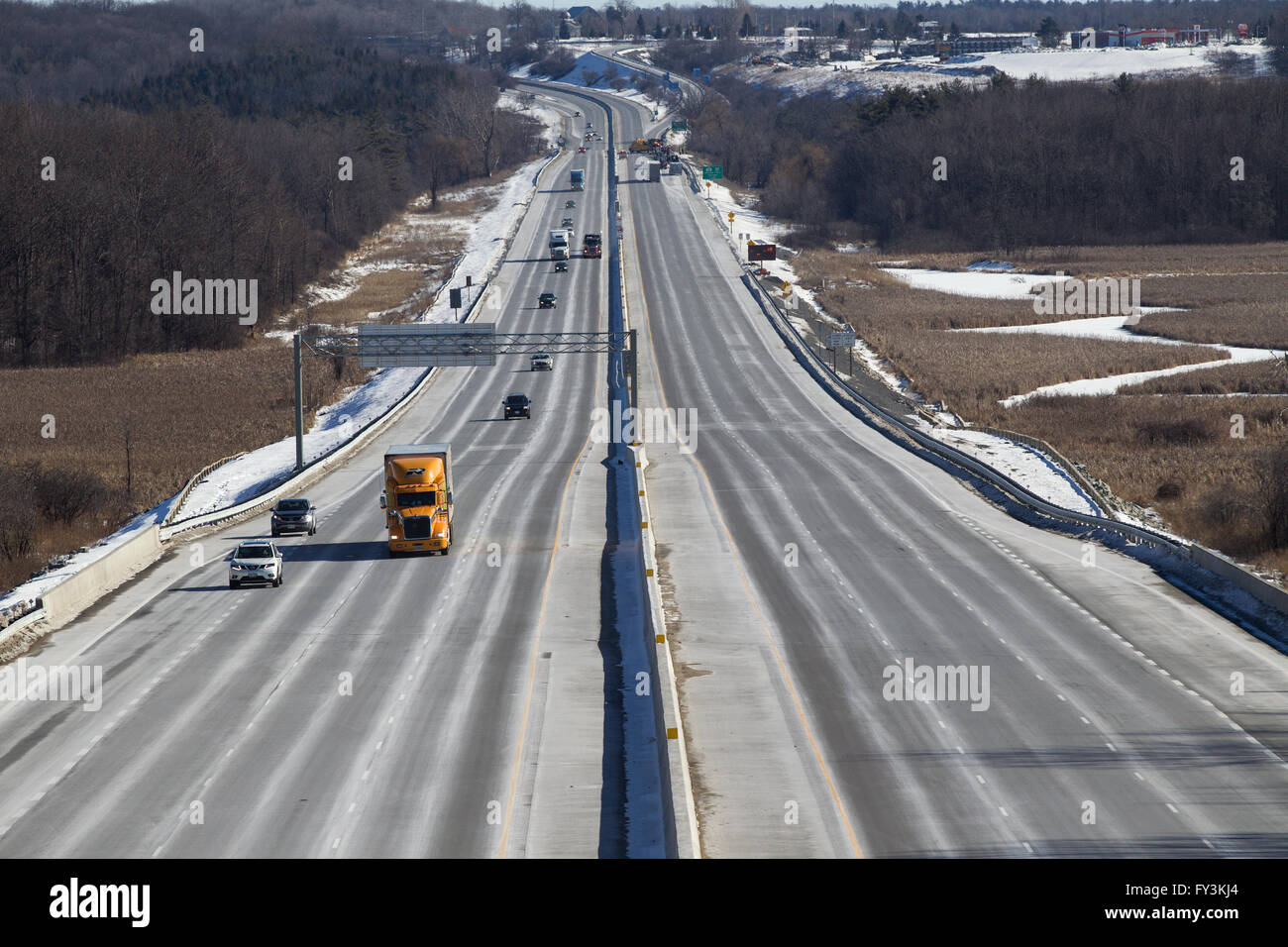 Cars and trucks drive on highway 401 in Kingston, Ontario, on March 3, 2016. Stock Photo