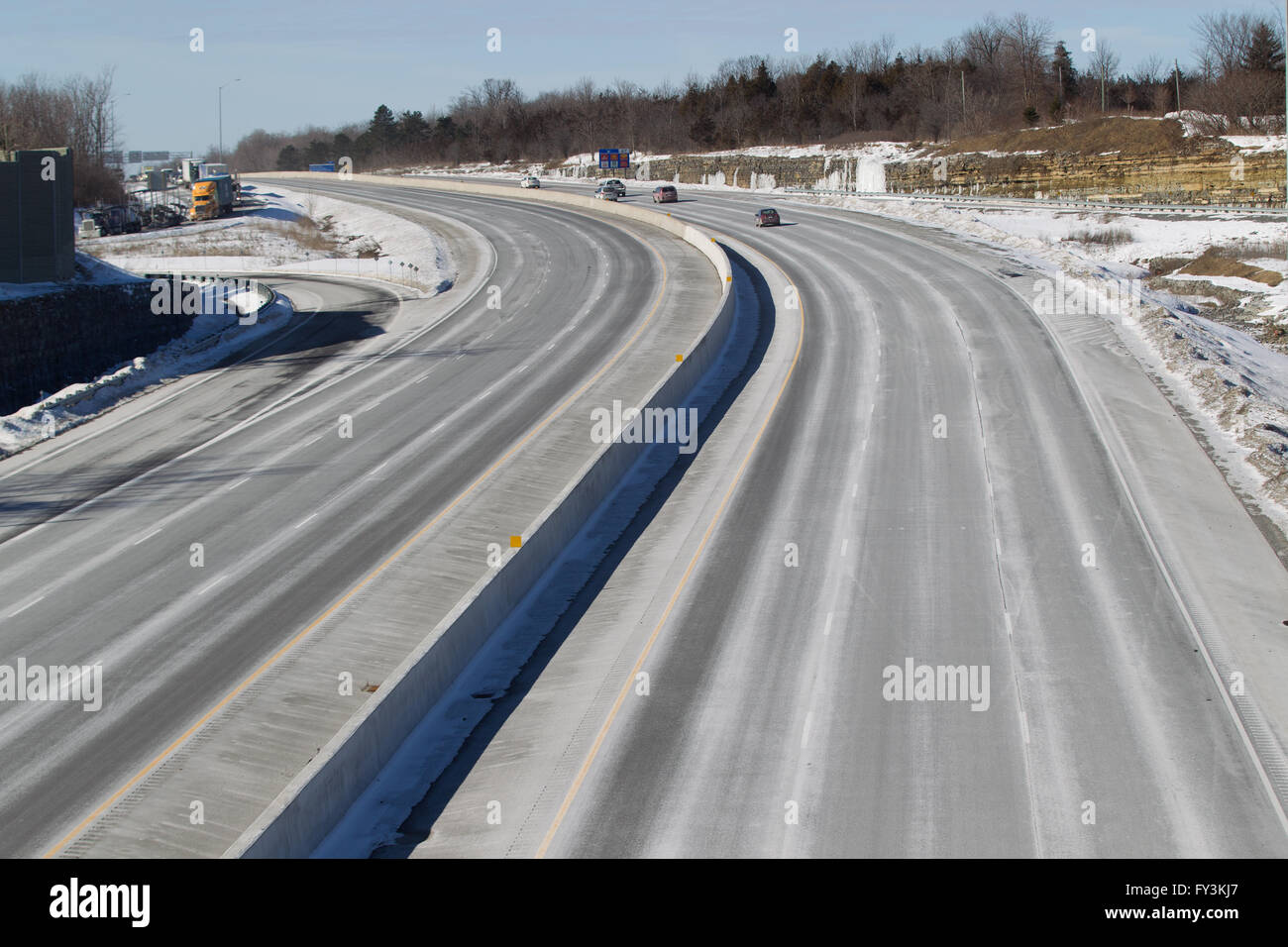 Cars and trucks drive on highway 401 in Kingston, Ontario, on March 3, 2016. Stock Photo