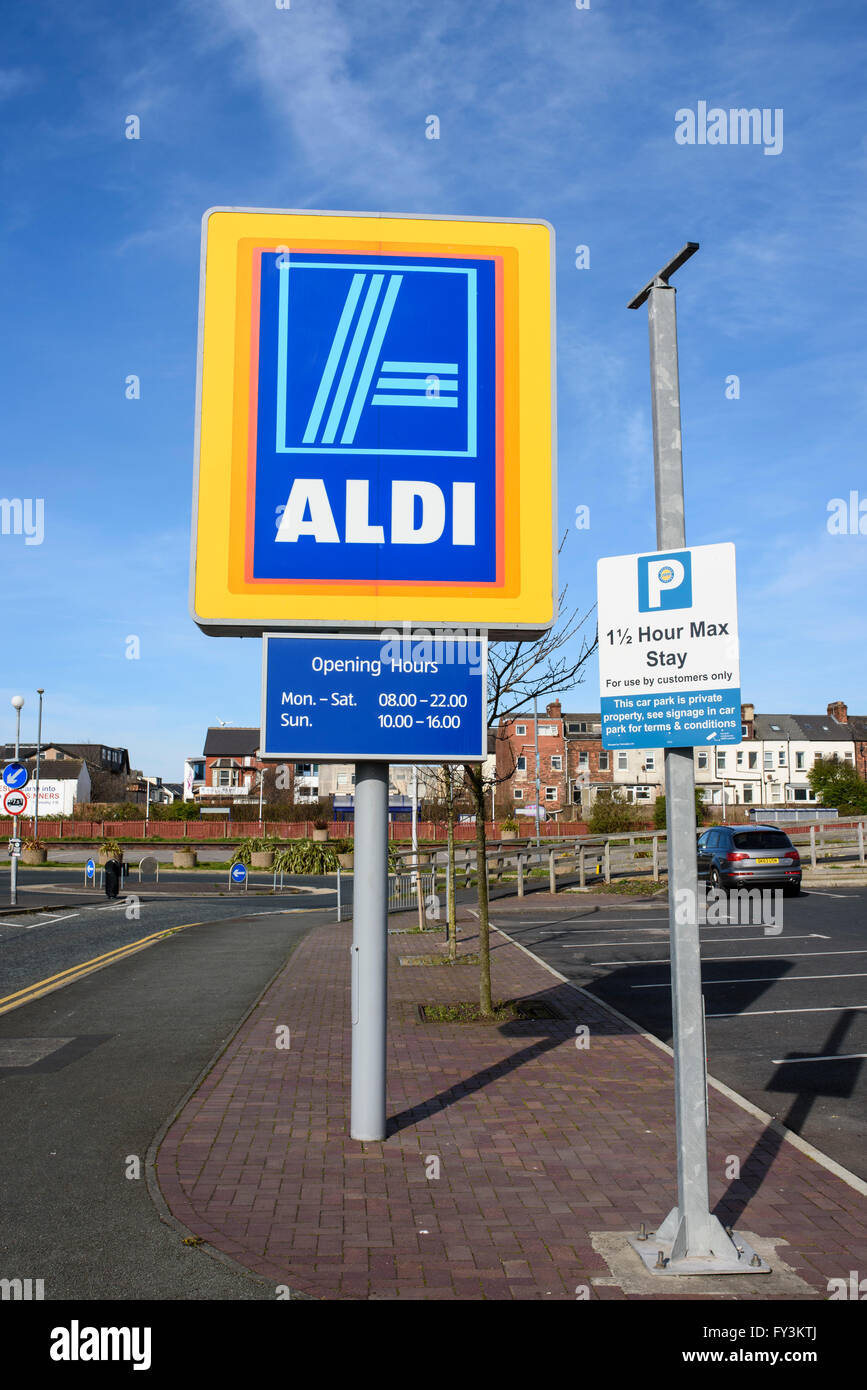 Aldi sign at the entrance to the car park of a large Aldi supermarket