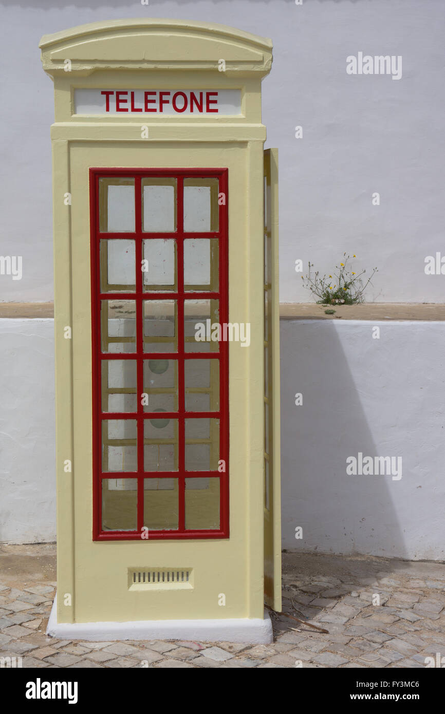 Cream coloured traditional telephone box. Stock Photo