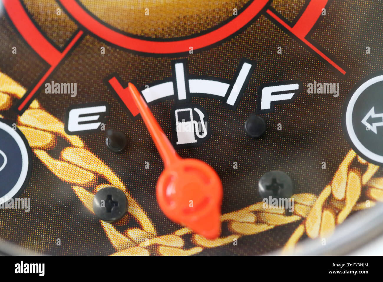 Fuel gauge with warning indicating low fuel tank,Gas gauge indicating white icon for gas station. Stock Photo