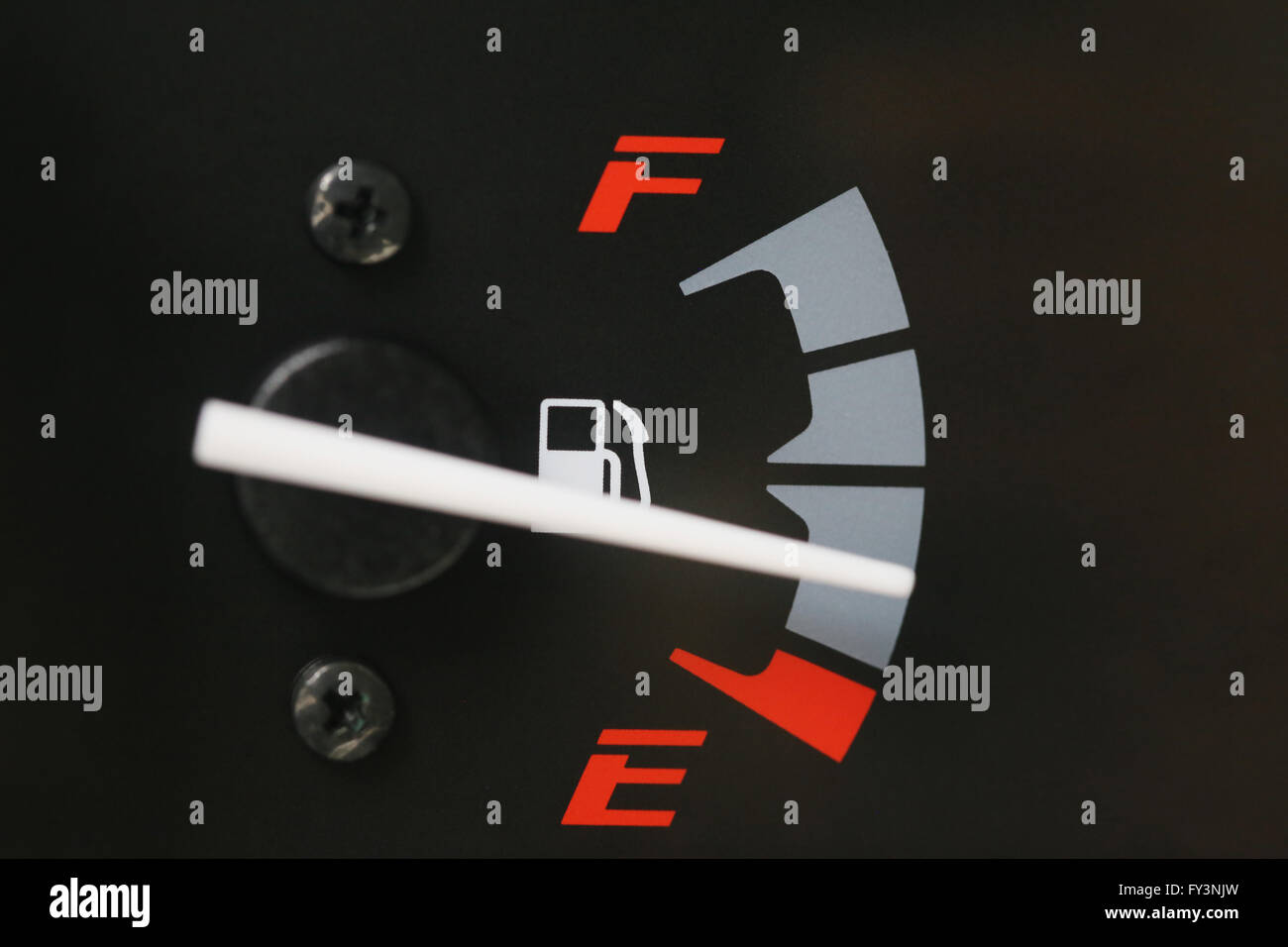 Fuel gauge with warning indicating low fuel tank,Gas gauge indicating white icon for gas station. Stock Photo