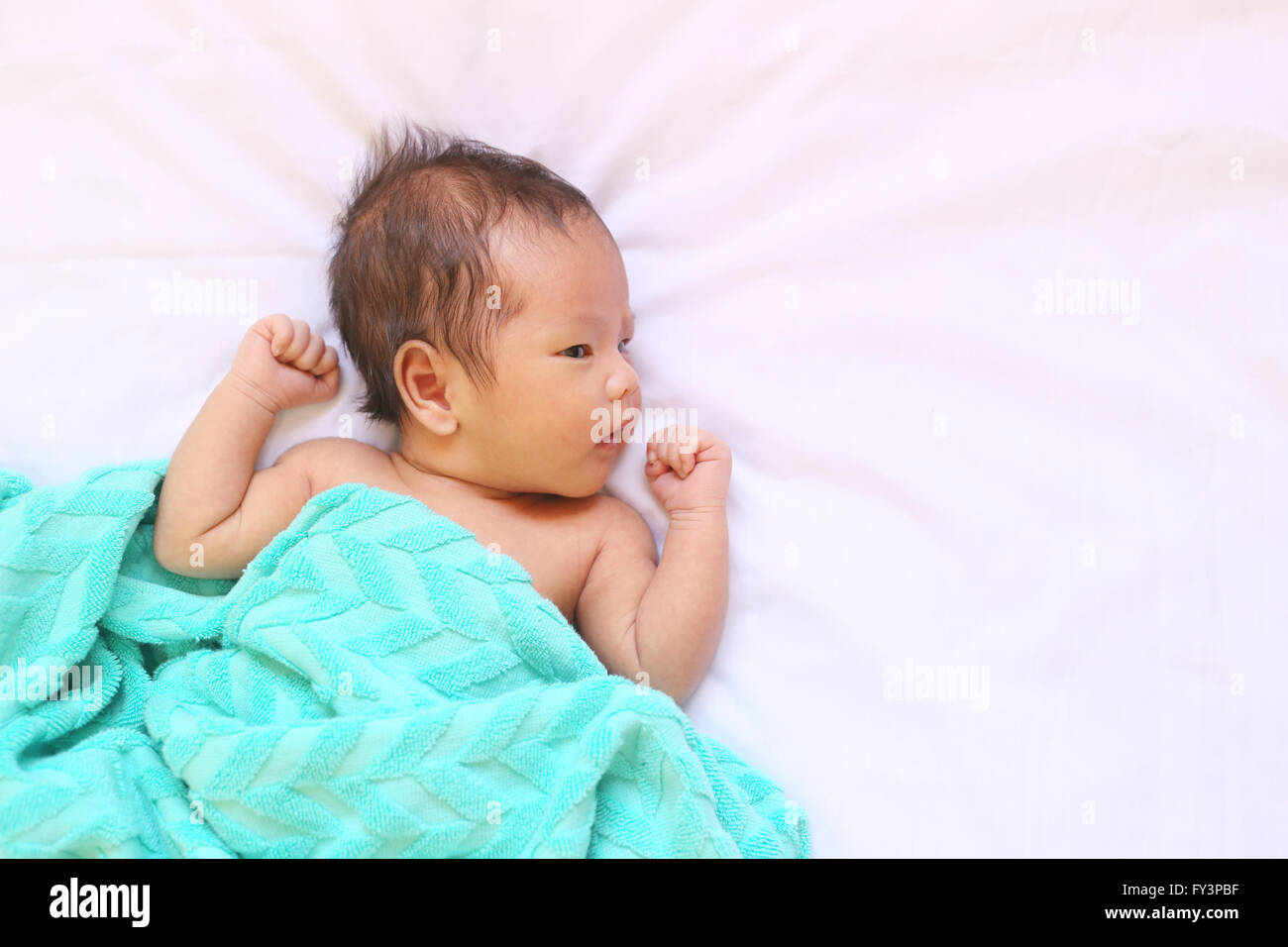 Newborn baby of asia relax in a good mood on white bed and looked happy,good health. Stock Photo