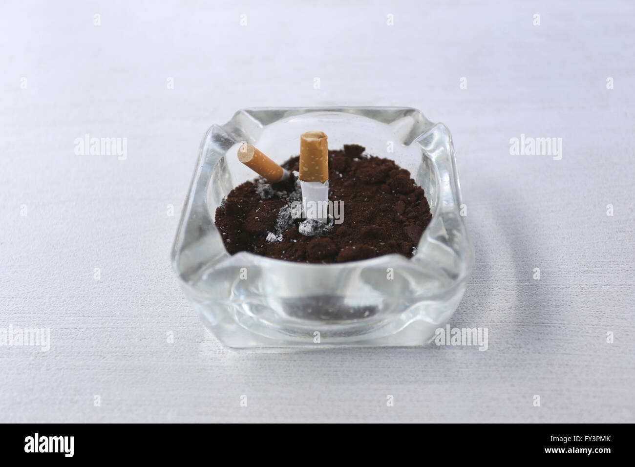 Ashtray on the white table for disposable cigarette after smoking it