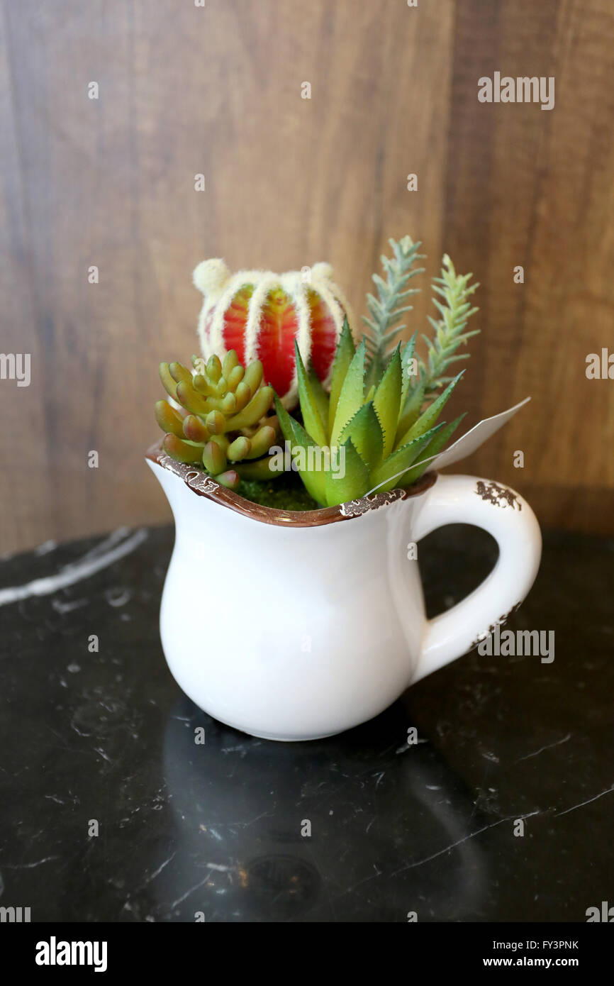 Fake flowers (cactus tree) for decoration on table in the cafe