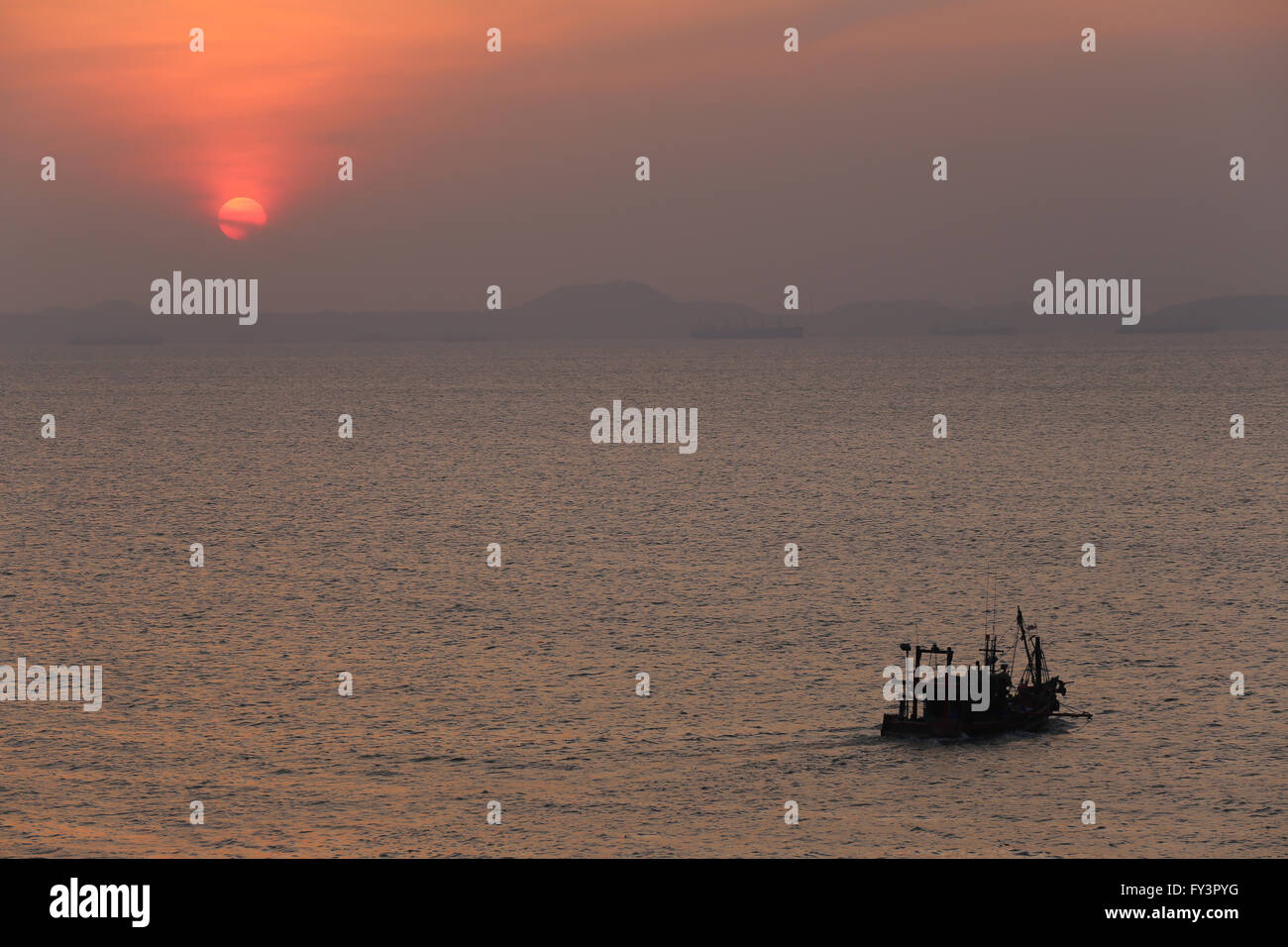 fishing boat on sea in the evening and sunset,image concept of life to while some people are going with sleep but there are some Stock Photo