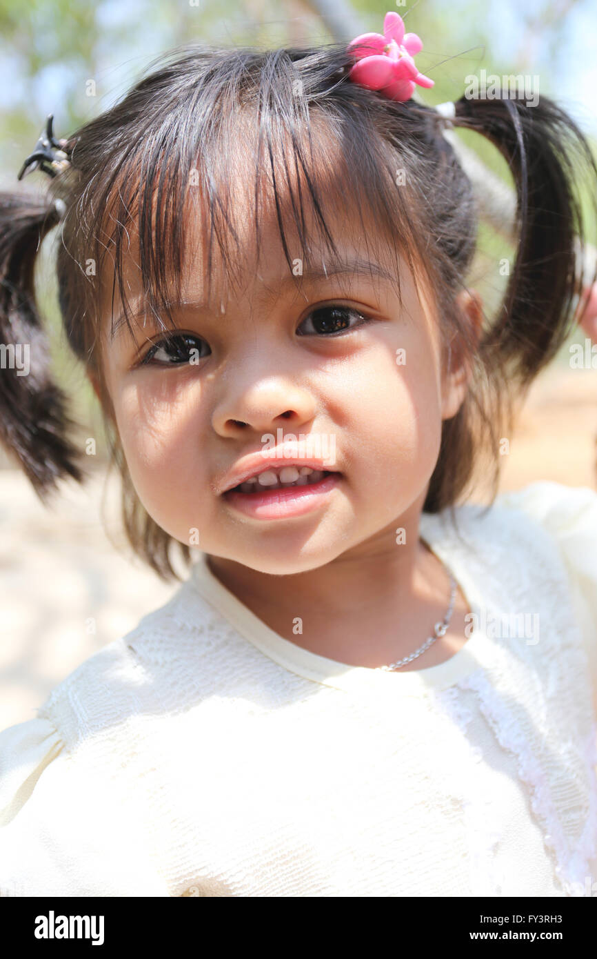 Asian girl aged about two years old is smiling,She was happy after eating sweets. Stock Photo