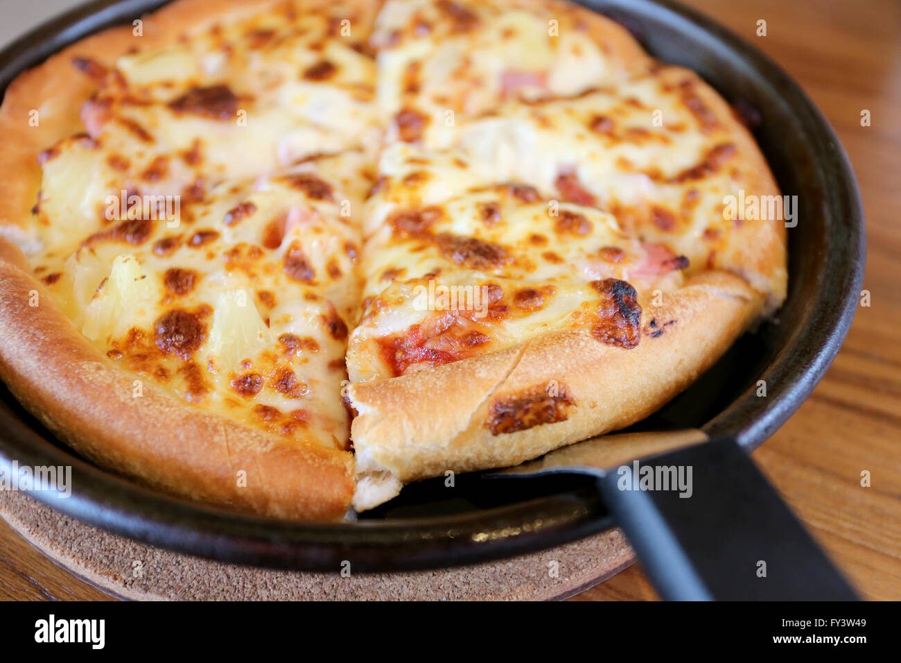 traditional of hot cheese pizza on pan in the restaurant Stock Photo