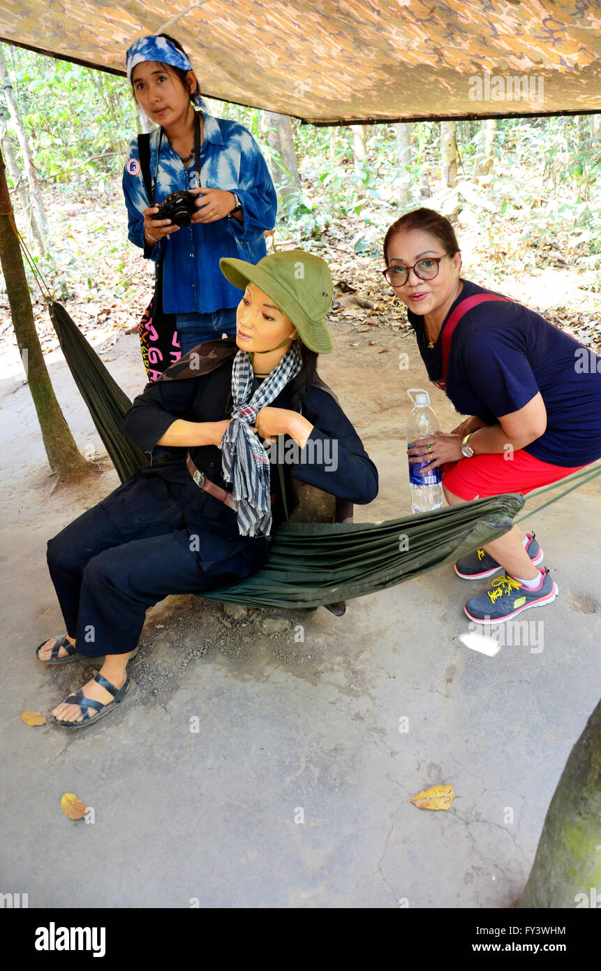 Thai women take photo with figurine vietnamese soldier for show traveler at Cu Chi tunnels in Ho Chi Minh, Vietnam Stock Photo