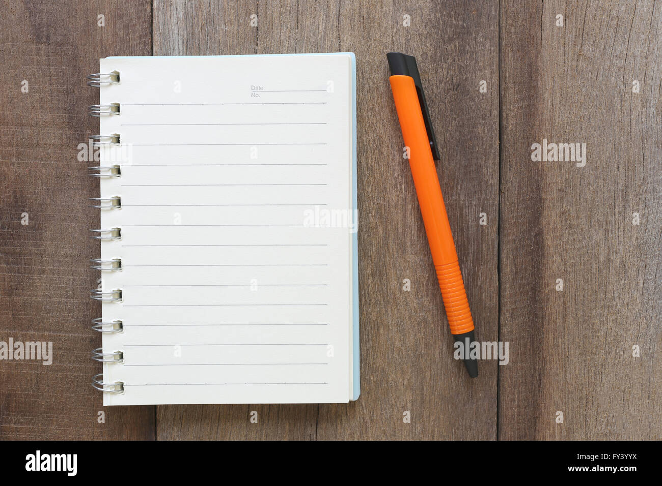 Notebook and pen on old wood for the design background,Blank paper to take notes or add text to it. Stock Photo