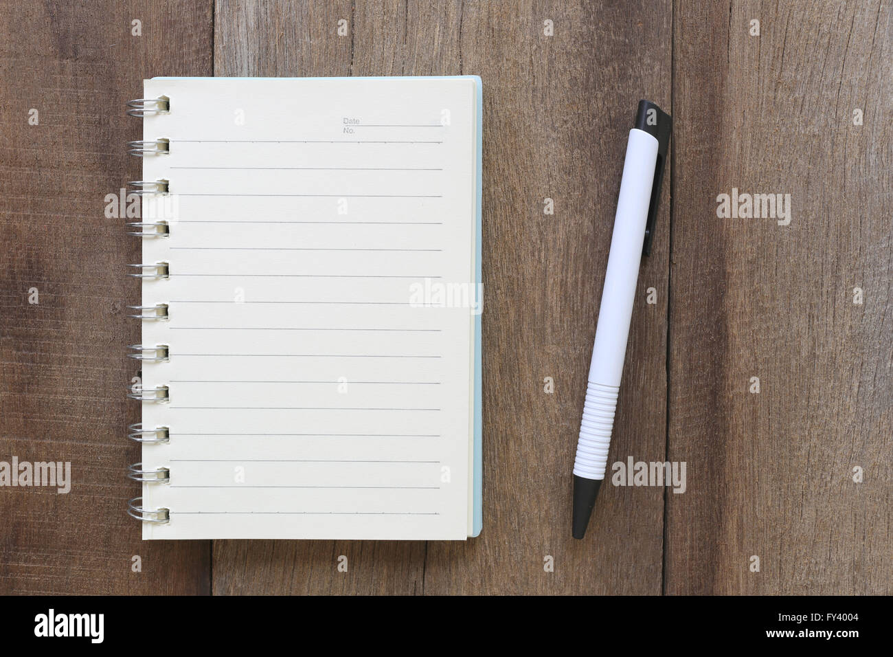 Notebook and pen on old wood for the design background,Blank paper to take notes or add text to it. Stock Photo
