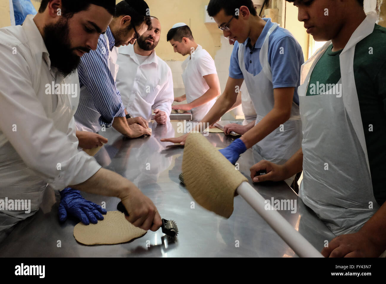 Jerusalem, Israel. 21st April, 2016. Jewish men prepare matzah, unleavened bread, for Passover, symbolic of the biblical exodus of the ancient Hebrews from slavery in Egypt to freedom, in which not having had time to wait for dough to rise before leaving Egypt, they journeyed into the desert with unleavened bread. Credit:  Nir Alon/Alamy Live News Stock Photo