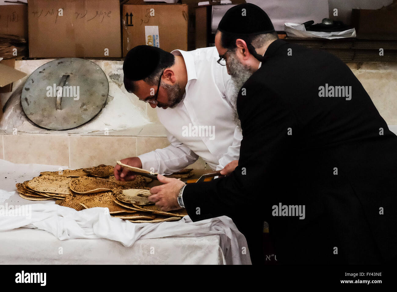 Jerusalem, Israel. 21st April, 2016. Jewish men prepare matzah, unleavened bread, for Passover, symbolic of the biblical exodus of the ancient Hebrews from slavery in Egypt to freedom, in which not having had time to wait for dough to rise before leaving Egypt, they journeyed into the desert with unleavened bread. Credit:  Nir Alon/Alamy Live News Stock Photo