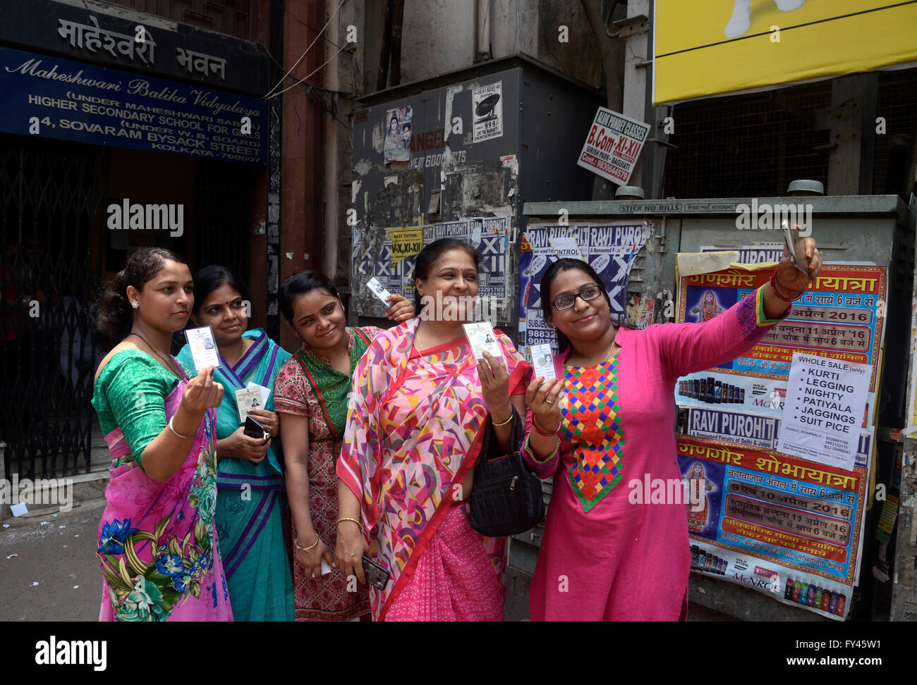 Kolkata, India. 21st Apr, 2016. Women busy taking selfie after casting their vote in front of polling station. People of West Bengal vote for the 62 assembly seats over four district along with seven of North Kolkata seat. This the third phase of six phase West Bengal Legislative election. Credit:  Saikat Paul/Pacific Press/Alamy Live News Stock Photo