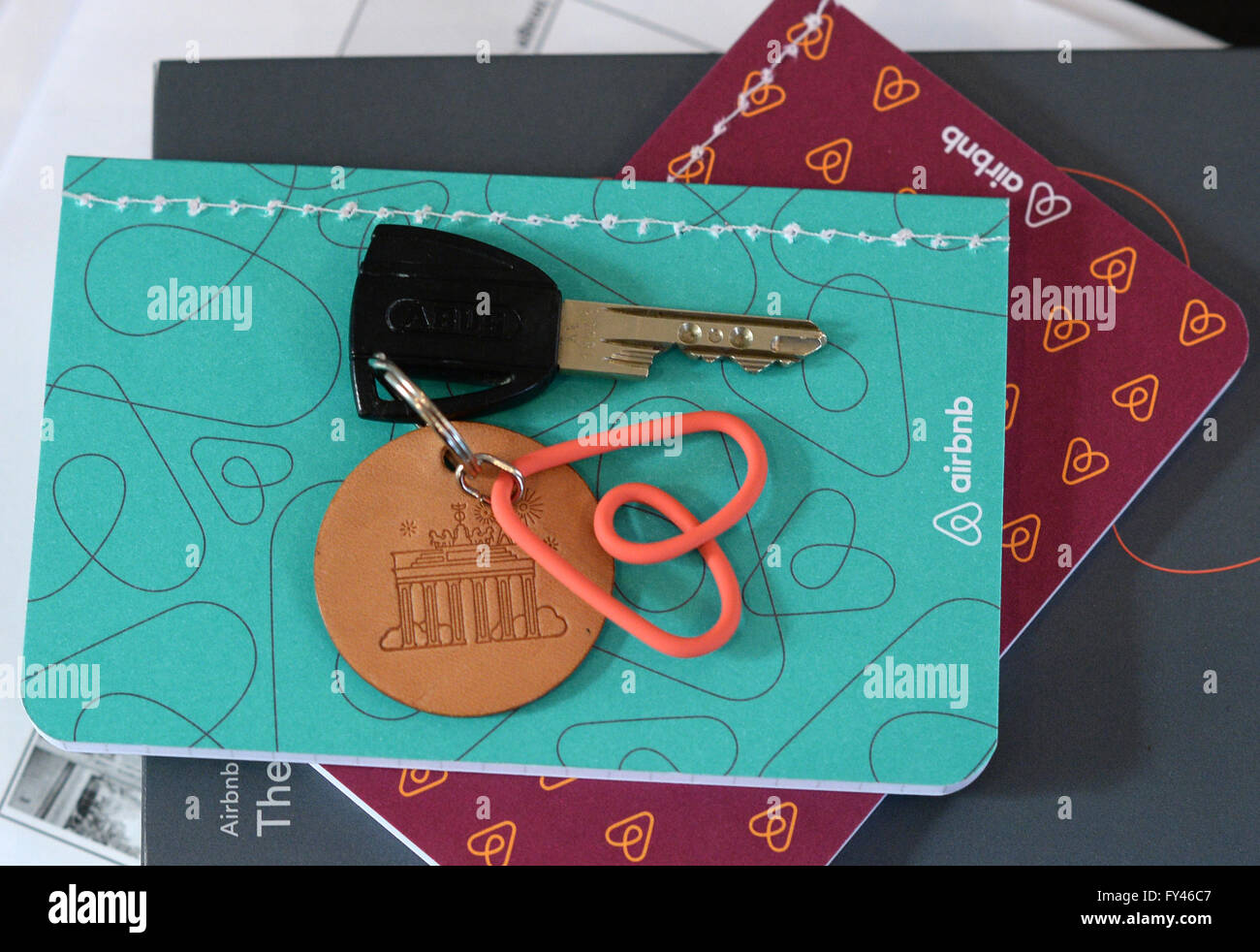 Berlin, Germany. 18th Apr, 2016. A keychain with the logo of the online  platform and community marketplace for private accommodations, Airbnb, lies  on a table and notebook in a vacation apartment in
