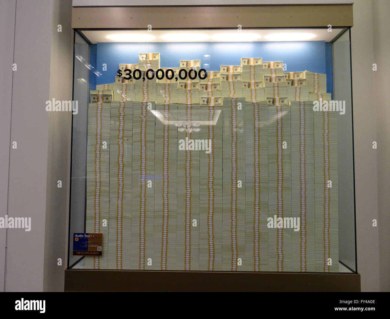 DENVER, COLORADO - JULY 7: Stack of Hundred dollar bills in glass display case equally 30 million dollars inside United States Mint in Denver, Colorado.  July 7, 2015. Stock Photo