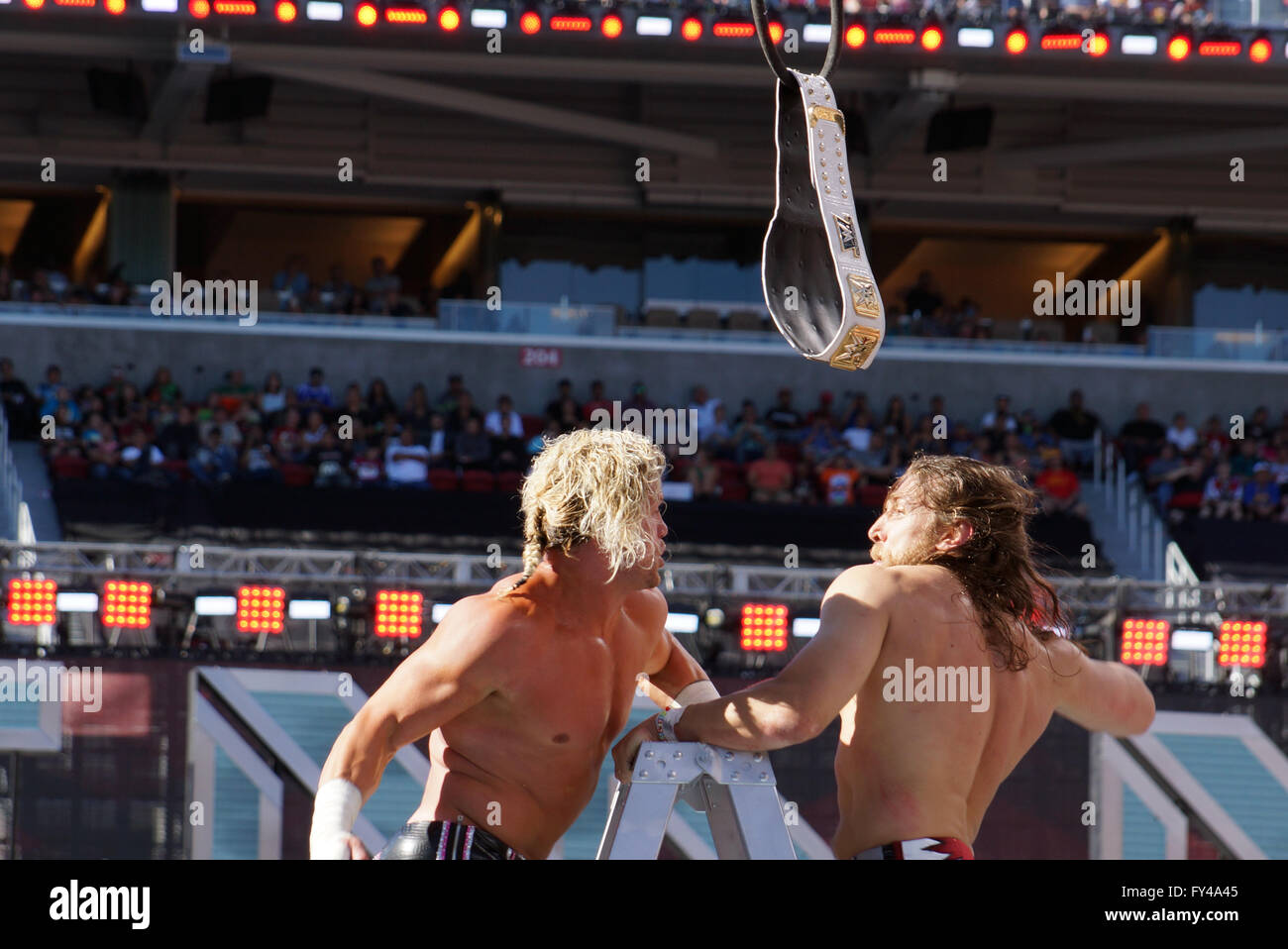 SANTA CLARA - MARCH 29: Dolph Ziggler and Daniel Bryan exchange punches on top ladder for the Intercontinental championship belt as it hangs in the air with  during ladder match at Wrestlemania 31 with crowd in the distance at the Levi's Stadium in Santa Clara, California on March 29, 2015. Stock Photo