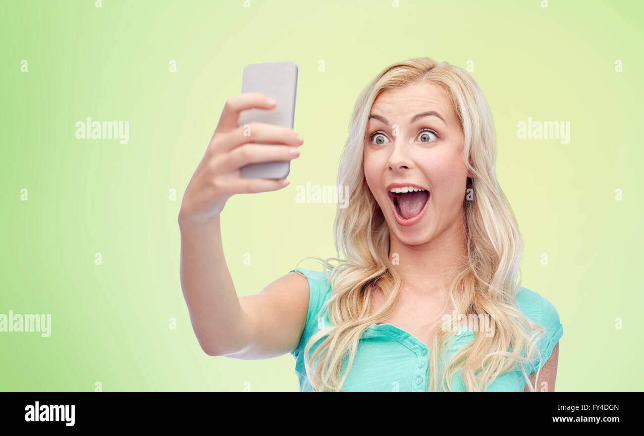 smiling young woman taking selfie with smartphone Stock Photo - Alamy
