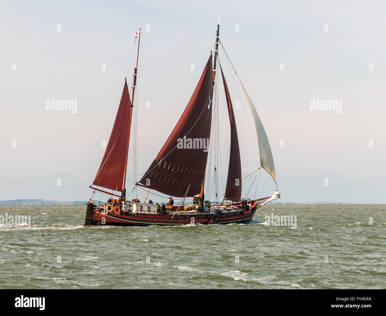 Classic Dutch sailboat of the brown fleet sailing on the Wadden Sea in the Netherlands Stock Photo