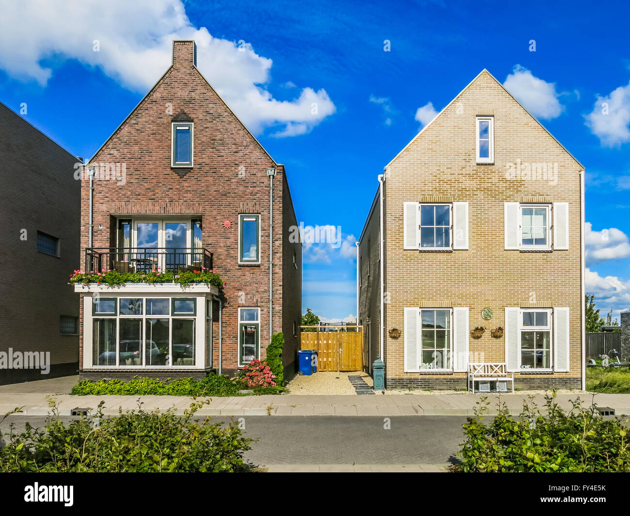 Two family houses in suburban neighbourhood street in Almere in the province of Flevoland near Amsterdam,  Netherlands Stock Photo