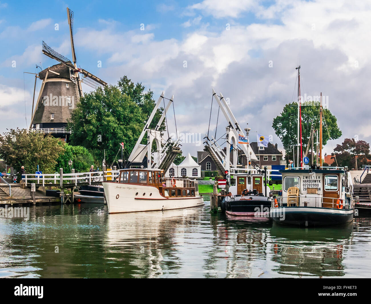 Windmill, bridge and boats in the harbour of Harderwijk in de province of Gelderland, Netherlands Stock Photo
