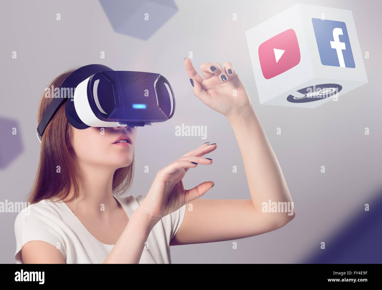 Varna, Bulgaria - March 10, 2016: Woman in VR headset looking up and interacting with Facebook Youtube Steam VR content. Stock Photo