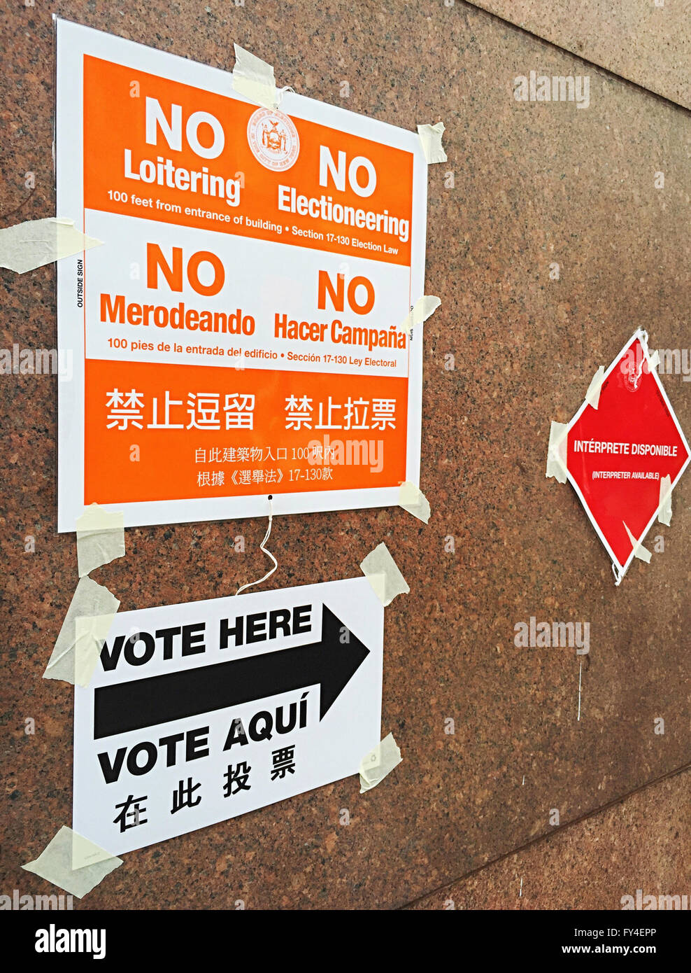 'No Loitering or Electionering' and 'Vote Here' Directional Signs in English, Spanish and Chinese, NYC Polling Location, USA Stock Photo