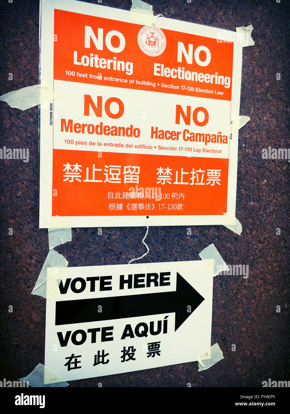 'No Loitering or Electionering' and 'Vote Here' Directional Signs in English, Spanish and Chinese, NYC Polling Location, USA Stock Photo