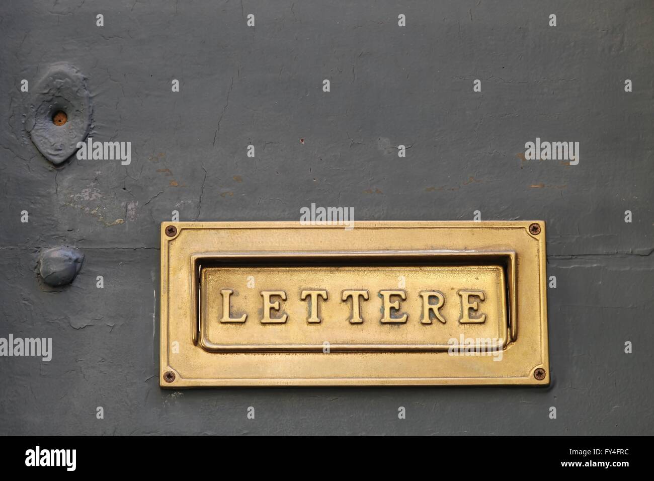 Details of an old Italian letter box on wooden door in Italy Stock Photo